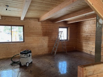 Living room, sanding log walls for a smooth finish